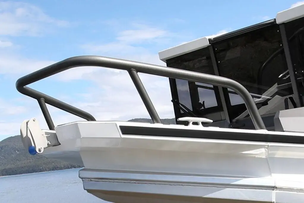 Matt black bent tube bow rail on a white aluminium boat