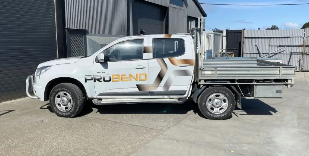 White Probend work ute with copper and charcoal signwriting outside the workshop