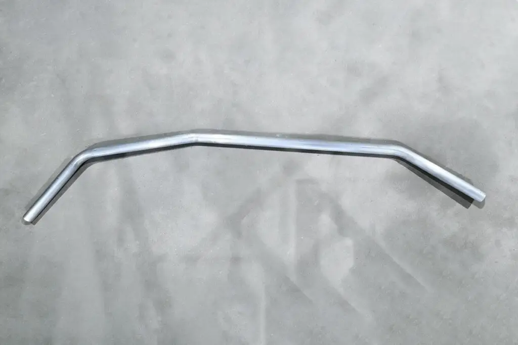 Aluminium bar with three bends on a concrete floor