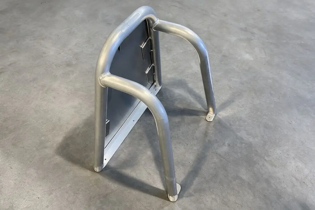 Aluminium frame with bent tube legs welded to a plate, made by Probend