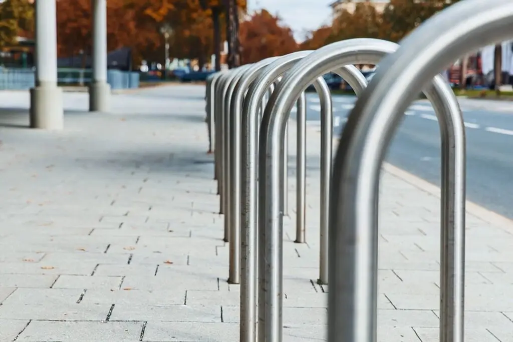 Row of stainless steel bike parking racks bent from round tube